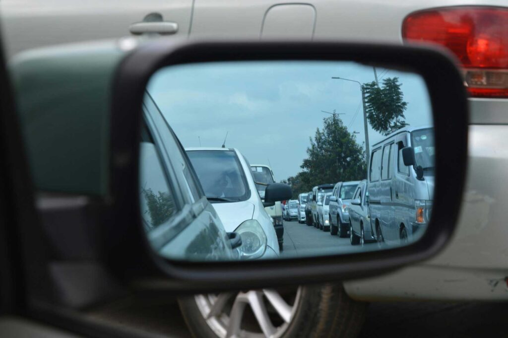 a view of traffic gridlock in a side view mirror